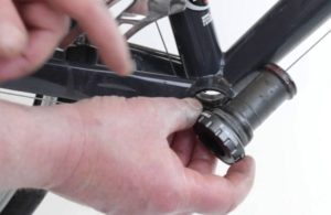 Bottom bracket (BB). Cartridge BB being installed into the BB shell on the bicycle frame.
