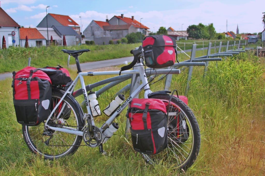 Touring bicycle. MTB wheels with fat tyres, road bike style drop bars (most comfortable for road riding), lots of room for luggage, steel frame.