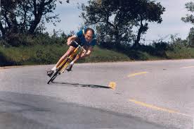 Cornering on pavement (fast). Both bicycle and the body are leaned into a corner.