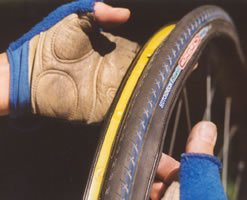 Placing one side of tyre on the rim. This should go easily, tyre might even fall off the rim when just one side is mounted.
