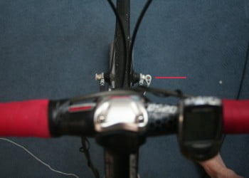 View of the front wheel axle over the bars. In the picture, up is the front side of the bike. This stem is on the border of being too short, but not too much of axle protrusion is visible so it's probably acceptable.