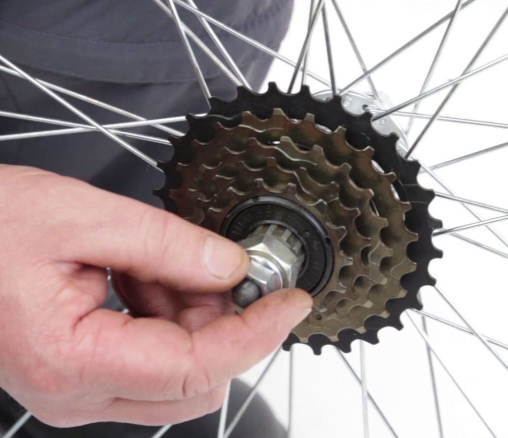 Freewheel key is inserted into the splines. Here, a nut holding the wheel on the bicycle is used to prevent the key from falling out accidentally. This is not necessary, and if it's done, do not tighten the nut, not even a little.