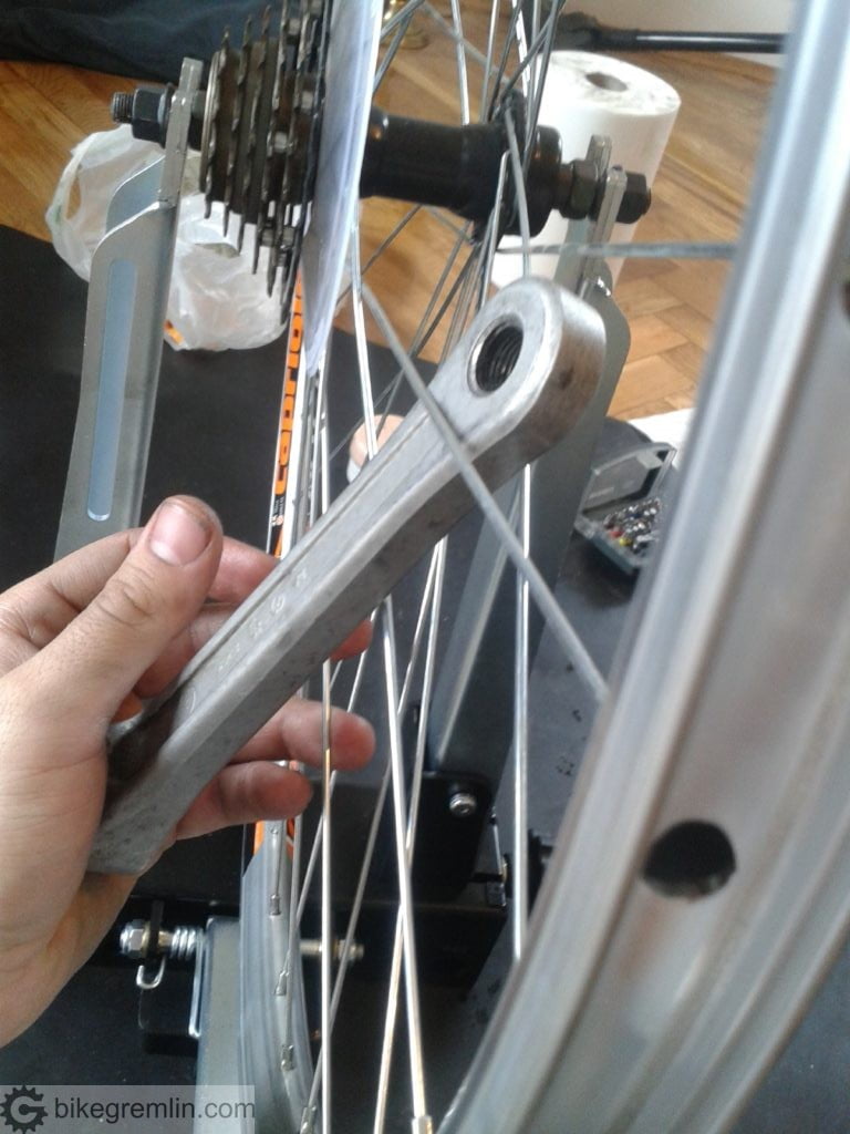 Stress relieving spokes. Using an old aluminium left crank arm. Aluminium is softer than steel (spoke material), so the spokes are not damaged when "tortured" like this.