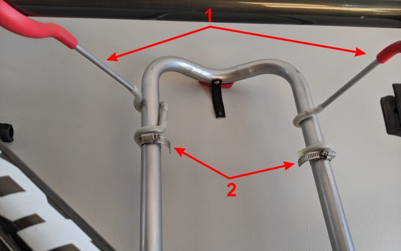 Bicycle hanger height (1) is easily adjusted using hose clamps (2)