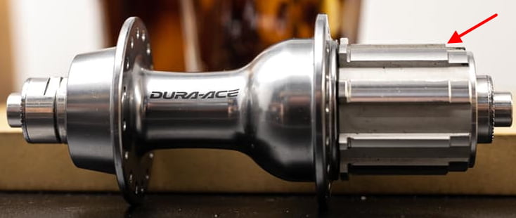 Shimano Dura-Ace 7800 "10 speed only" rear hub, with an arrow showing the "higher" spline section